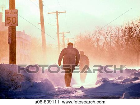 people walking on a cold winter day in blizzard conditions View Large Photo Image Stock Image - people walking on a cold winter day in blizzard conditions. Fotosearch