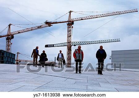 People walking on the upper part of the new Opera House, the home of The Norwegian National Opera and Ballet, and the national opera theatre in Norway. The building lies in the neighborhood of Bjorvika, Oslo, Norway, Europe View Large Photo Image Stock Photo - People walking on the upper part of the new Opera House, the home of The Norwegian National Opera and Ballet, and the national opera theatre in Norway. The building lies in the neighborhood of Bjorvika, Oslo, Norway, Europe. Fotosearch