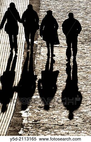 people walking paved street with long shadows, view from above View Large Photo Image Stock Photography - people walking paved street with long shadows, view from above. Fotosearch