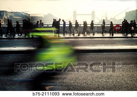 People walking through London Bridge and a moving bicycle in the foreground and Tower Bridge in the background. London, England, UK, Europe View Large Photo Image Stock Image - People walking through London Bridge and a moving bicycle in the foreground and Tower Bridge in the background. London, England, UK, Europe. Fotosearch