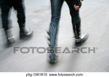Stock Image - people wearing leather boots running. Fotosearch