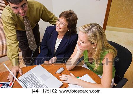 People working in an office with laptop computer View Large Photo Image Stock Image - People working in an office with laptop computer. Fotosearch