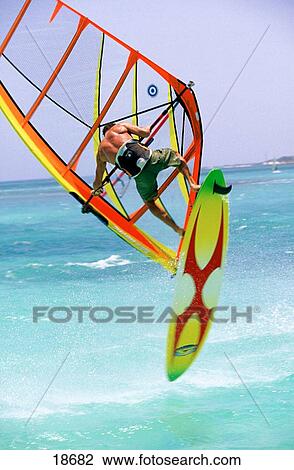 Stock Image - Performing a forward loop on a windsurfer in Aruba. Fotosearch