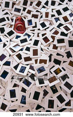 Stock Image - Person buried in pile of 35mm slides. Fotosearch