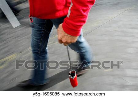 person carrying colourful closed umbrella in town View Large Photo Image Stock Photography - person carrying colourful closed umbrella in town. Fotosearch