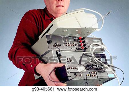 Stock Image - Person carrying stereo equipment and fax machine.. Fotosearch