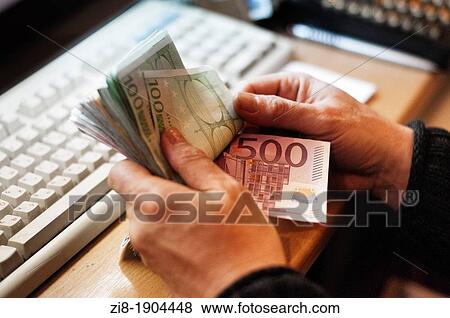 Stock Photo - Person counting cash. Fotosearch