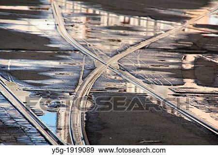 person crossing tram lines in city town View Large Photo Image Stock Photo - person crossing tram lines in city town. Fotosearch