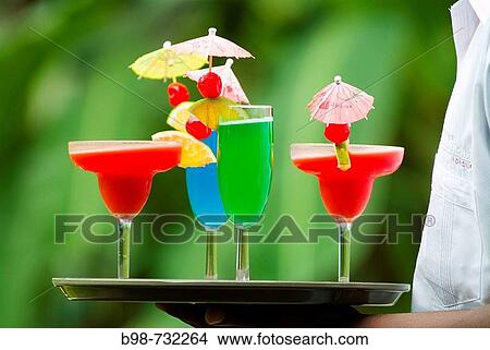 Person holding a tray of drinks, Pico Bonito Lodge, Honduras View Large Photo Image Picture - Person holding a tray of drinks, Pico Bonito Lodge, Honduras. Fotosearch