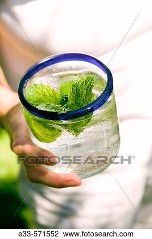Person holding glass of mineral water. View Large Photo Image Stock Image - Person holding glass of mineral water.. Fotosearch