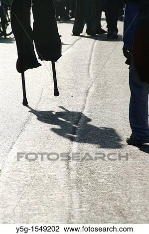 person man walking on stilts in street road in city town View Large Photo Image Stock Image - person man walking on stilts in street road in city town. Fotosearch