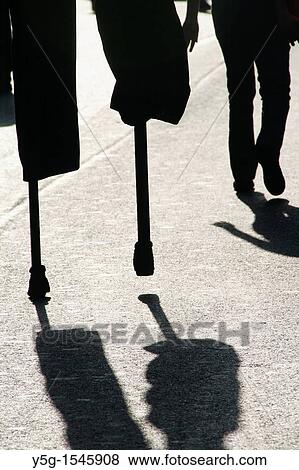 person man walking on stilts in street road in city town View Large Photo Image Stock Photo - person man walking on stilts in street road in city town. Fotosearch