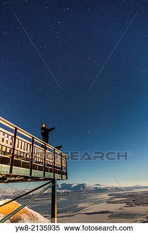 Stock Photography - Person on the observation deck at The Abisko Sky Station, Abisko, Lapland, Sweden. Cold temperatures as low as -47 celsius.. Fotosearch