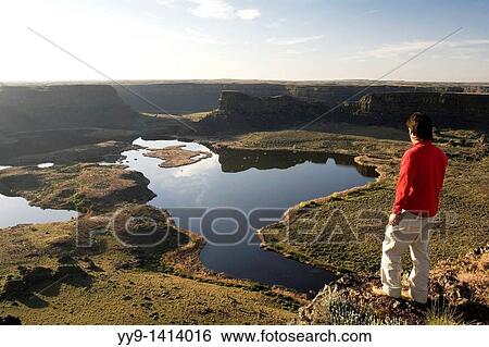 Person overlooking Dry Falls, Sun Lakes - Dry Falls State Park, Washington View Large Photo Image Stock Photograph - Person overlooking Dry Falls, Sun Lakes - Dry Falls State Park, Washington. Fotosearch