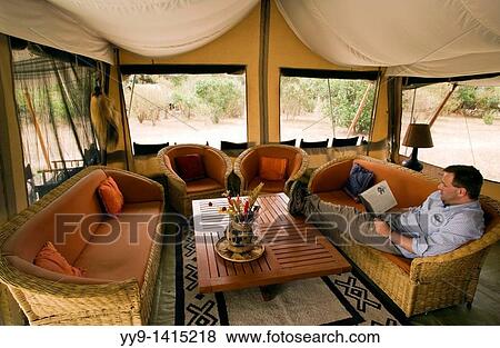 Stock Photo - Person relaxing at JK Mara Camp - near Masai Mara National Reserve, Kenya. Fotosearch