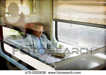Person sitting and reading in a train carriage traveling in Morocco, Africa View Large Photo Image Stock Photograph - Person sitting and reading in a train carriage traveling in Morocco, Africa. Fotosearch