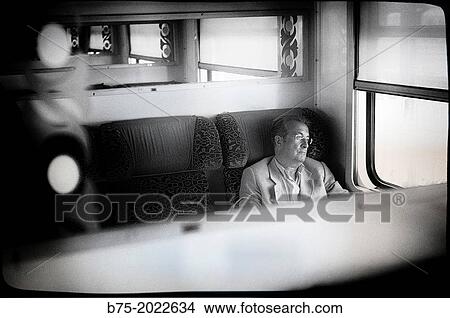 Person sitting on a train carriage traveling in Morocco, Africa View Large Photo Image Picture - Person sitting on a train carriage traveling in Morocco, Africa. Fotosearch