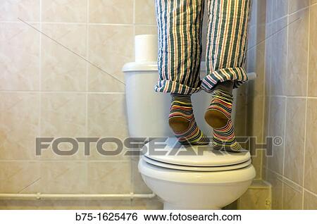 Person standing on toilet View Large Photo Image Stock Photograph - Person standing on toilet. Fotosearch
