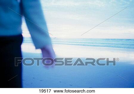 Person strolls on beach View Large Photo Image Stock Photo - Person strolls on beach. Fotosearch