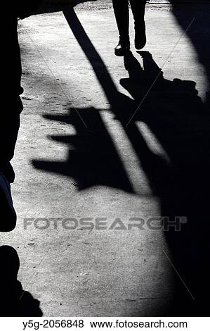 person walking by traffic lights in street road in city town View Large Photo Image Stock Photo - person walking by traffic lights in street road in city town. Fotosearch