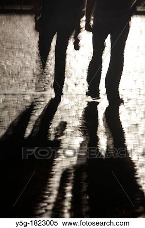 person walking on wet cobbles in street road at night View Large Photo Image Stock Photography - person walking on wet cobbles in street road at night. Fotosearch
