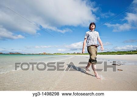 Person walks along scenic white sand beach, Gimsoya, Lofoten islands, Norway View Large Photo Image Stock Photo - Person walks along scenic white sand beach, Gimsoya, Lofoten islands, Norway. Fotosearch