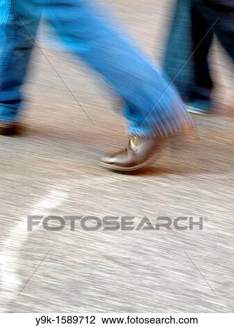 Person wearing jeans walking in town View Large Photo Image Stock Image - Person wearing jeans walking in town. Fotosearch