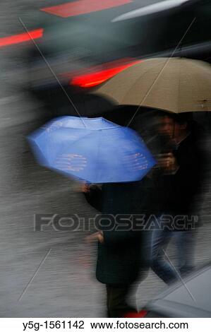 person with umbrella crossing road in rain View Large Photo Image Stock Image - person with umbrella crossing road in rain. Fotosearch