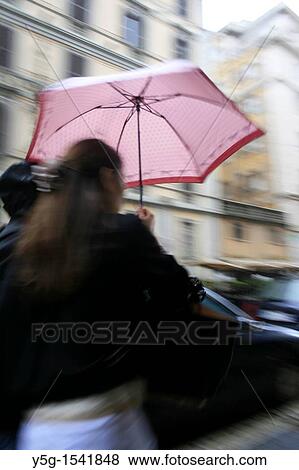person with umbrella in heavy rain in town View Large Photo Image Stock Photo - person with umbrella in heavy rain in town. Fotosearch