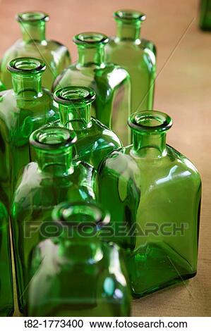 Stock Image - perspective of numerous bottles of green glass. Fotosearch