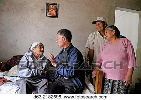 PERU. Guaybo, a squatter settlement in the Diocese of Lurin, South Lima. Korean/American missionary priest visiting home of 102-year-old Victoria. Martinez. View Large Photo Image Stock Photography - PERU. Guaybo, a squatter settlement in the Diocese of Lurin, South Lima. Korean/American missionary priest visiting home of 102-year-old Victoria. Martinez.. Fotosearch