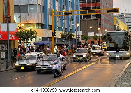 Stock Image - Peru, Lima, Avenida Emancipacion, street scene, traffic, moving, headlight, bus, car, motorcycle, bus lane, sidewalk, pedestrian,.. Fotosearch
