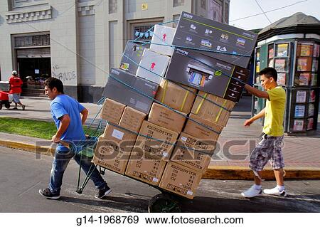 Peru, Lima, Jiron de la Union, street scene, Hispanic, man, teen, delivery, deliveryman, job, pulling, boxes, office electronics, Epson printers, stack, tied, rope, cart, handcart, dolly, heavy lifting, assistant,. View Large Photo Image Stock Photo - Peru, Lima, Jiron de la Union, street scene, Hispanic, man, teen, delivery, deliveryman, job, pulling, boxes, office electronics, Epson printers, stack, tied, rope, cart, handcart, dolly, heavy lifting, assistant,.. Fotosearch
