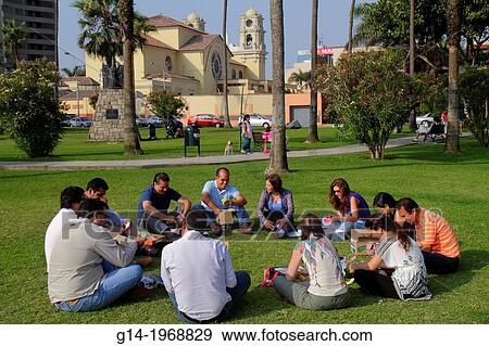 Peru, Lima, Miraflores, Malecon de la Reserva, Parque Domodossola, urban park, landscaping, trees, green space, lawn, Hispanic, man, woman, circle, coworker, teamwork, exercise, outdoor team building activity,. View Large Photo Image Stock Photo - Peru, Lima, Miraflores, Malecon de la Reserva, Parque Domodossola, urban park, landscaping, trees, green space, lawn, Hispanic, man, woman, circle, coworker, teamwork, exercise, outdoor team building activity,.. Fotosearch