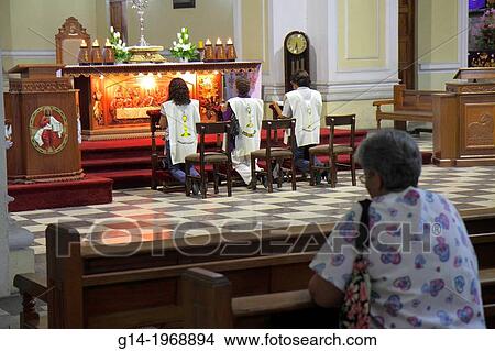 Peru, Tacna, Avenida San Martin, La Catedral de Tacna, cathedral, church, Catholicism, religion, praying, kneeling, Hispanic, woman, altar, eucharistic, assistant, lectern, Last Supper, carving, Christ,. View Large Photo Image Picture - Peru, Tacna, Avenida San Martin, La Catedral de Tacna, cathedral, church, Catholicism, religion, praying, kneeling, Hispanic, woman, altar, eucharistic, assistant, lectern, Last Supper, carving, Christ,.. Fotosearch