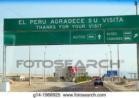 Peru, Tacna, Pan American Highway, approaching Chile, land border, crossing point, checkpoint, highway, sign, bilingual, Spanish, English, thanks for your visit, arrow, direction car, truck, bus, building,. View Large Photo Image Stock Photography - Peru, Tacna, Pan American Highway, approaching Chile, land border, crossing point, checkpoint, highway, sign, bilingual, Spanish, English, thanks for your visit, arrow, direction car, truck, bus, building,.. Fotosearch