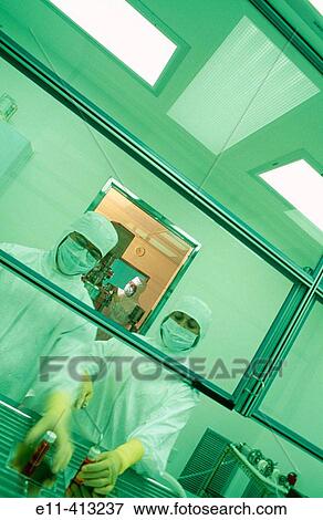 Stock Photo - Pharmaceutical workers in clean room. Fotosearch