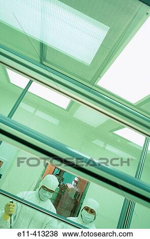 Pharmaceutical workers in clean room View Large Photo Image Stock Photo - Pharmaceutical workers in clean room. Fotosearch