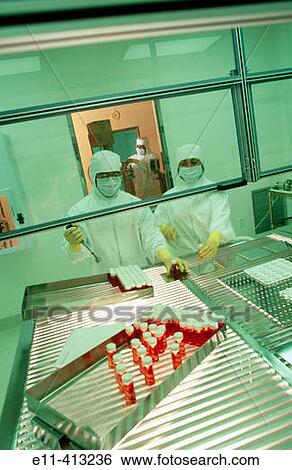 Pharmaceutical workers in clean room View Large Photo Image Stock Photograph - Pharmaceutical workers in clean room. Fotosearch