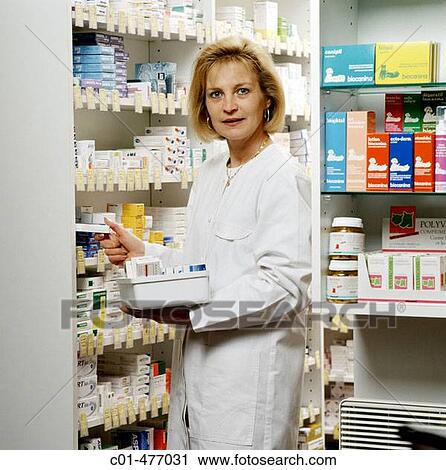 Pharmacist technician stacking drugs into shelves View Large Photo Image Stock Image - Pharmacist technician stacking drugs into shelves. Fotosearch
