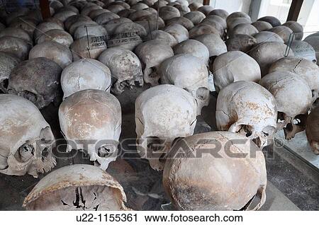 Stock Image - Phnom Penh (Cambodia): skulls of some victims of the Khmer Rouge regime at the Killing Fields of Choeung Ek. Fotosearch