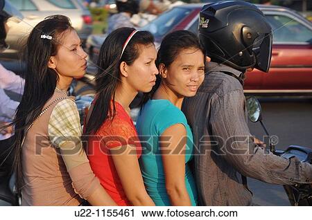 Phnom Penh (Cambodia): three women and a man on a motor-bike View Large Photo Image Stock Image - Phnom Penh (Cambodia): three women and a man on a motor-bike. Fotosearch