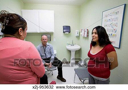 Phoenix, Arizona - The Centro de Salud, or Health Center, at Wesley Community Center Dr Steven Herf talks to a patient as Anita Schatz right translates The Centro de Salud has a bilingual staff and serves primarily persons without insurance It is supp View Large Photo Image Stock Image - Phoenix, Arizona - The Centro de Salud, or Health Center, at Wesley Community Center Dr Steven Herf talks to a patient as Anita Schatz right translates The Centro de Salud has a bilingual staff and serves primarily persons without insurance It is supp. Fotosearch