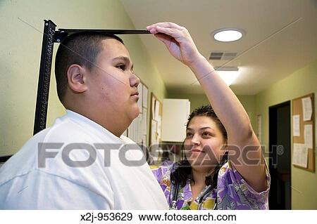 Phoenix, Arizona - The Centro de Salud, or Health Center, at Wesley Community Center Medical assistant Rebecca Mijares checks the height of a young patient The Centro de Salud has a bilingual staff and serves primarily persons without insurance It is s View Large Photo Image Stock Photo - Phoenix, Arizona - The Centro de Salud, or Health Center, at Wesley Community Center Medical assistant Rebecca Mijares checks the height of a young patient The Centro de Salud has a bilingual staff and serves primarily persons without insurance It is s. Fotosearch