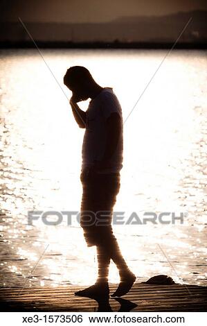 Stock Photograph - Phone talking at sunset. Fotosearch
