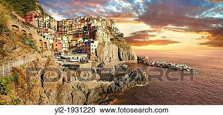Stock Image - Photo of the fishing port of Manarola at sunset, Cinque Terre National Park, Liguria, Italy. Fotosearch