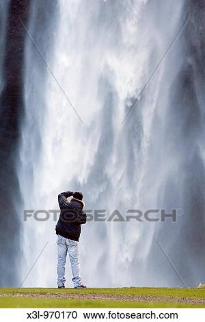Photographer in Seljalandsfoss waterfall Iceland View Large Photo Image Stock Image - Photographer in Seljalandsfoss waterfall Iceland. Fotosearch