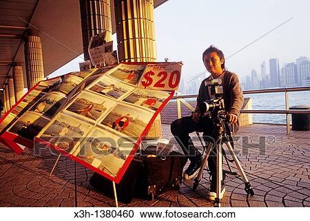 Stock Image - photographer of tourists at Tsim Sha Tsui, Kowloon Peninsula, Hong-Kong, People's Republic of China, Asia. Fotosearch