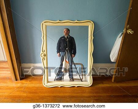 Stock Image - Photographer photographs personal property left by former owners in a foreclosed house in Providence, Rhode Island, United States. Fotosearch