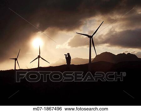 Photographer taking beautiful sunset pictures by Eolic park, wind power, wind energi, Codes mountains, Navarra, Spain, Europe View Large Photo Image Stock Photograph - Photographer taking beautiful sunset pictures by Eolic park, wind power, wind energi, Codes mountains, Navarra, Spain, Europe. Fotosearch